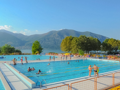 Outdoor pool with lake and mountain views.