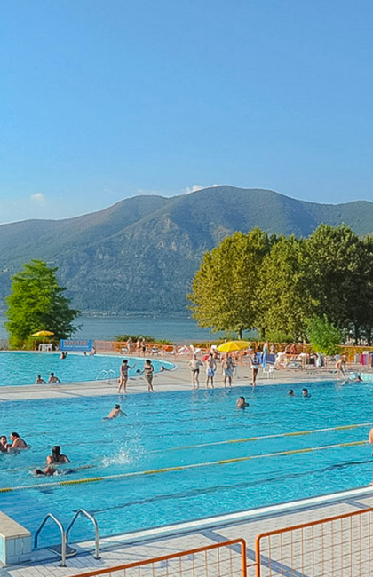 Outdoor pool with lake and mountain views.